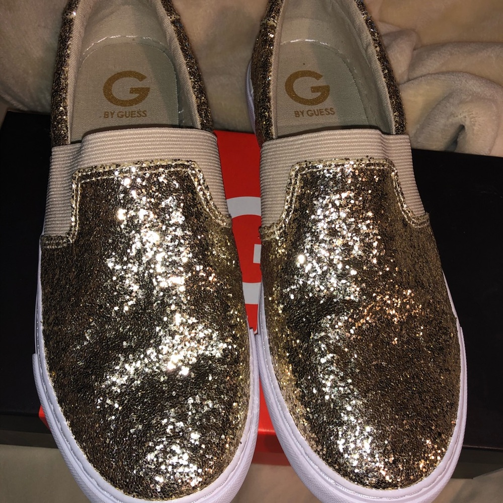 Gold Guess slip-on sneakers